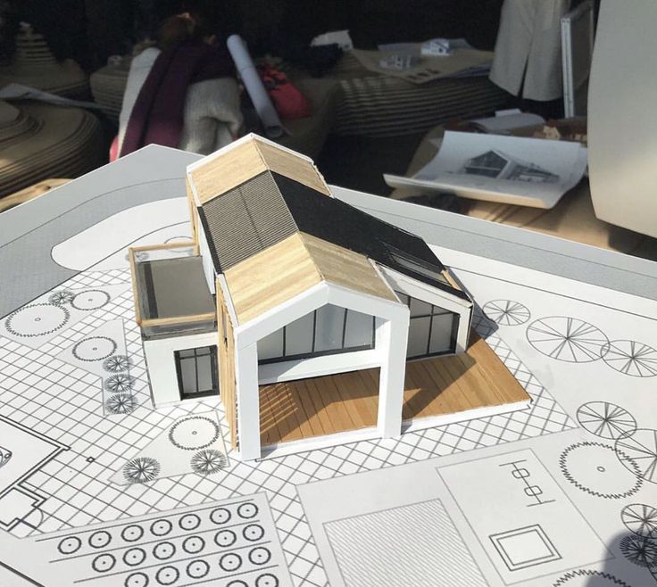 a model of a house on top of blueprints