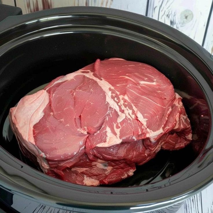 raw meat in the slow cooker ready to be cooked