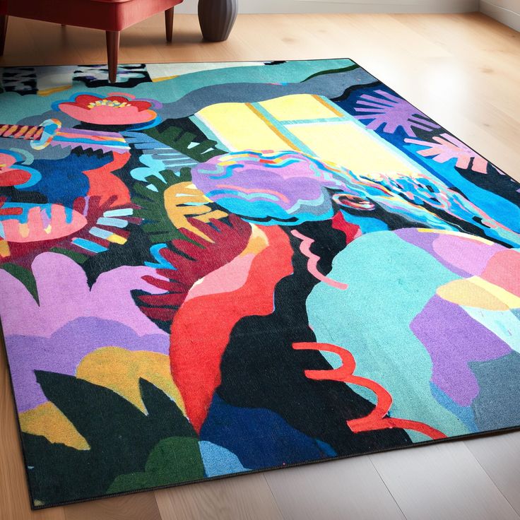 a multicolored rug is on the floor with a red chair in the background