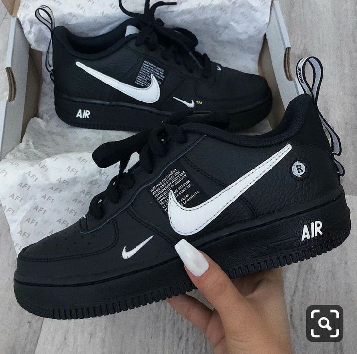 a pair of black and white nike air force sneakers