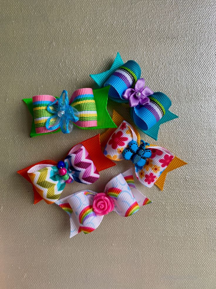 Five cute dog hair bows, two rainbow, one butterfly with flowers, and two striped with flower centers. Roanoke Rapids North Carolina, Candy Corn Dog, Striped Hair, Tulle Hair Bows, Dog Hair Bow, Small Hair Bows, Funky Hair, Dog Hair Bows, Flowers Butterfly