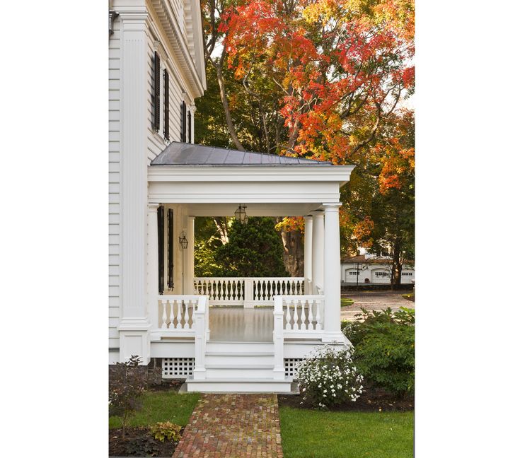 a white gazebo sitting in front of a house