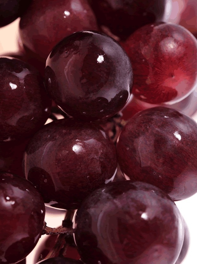 grapes are shown in close up on a white surface