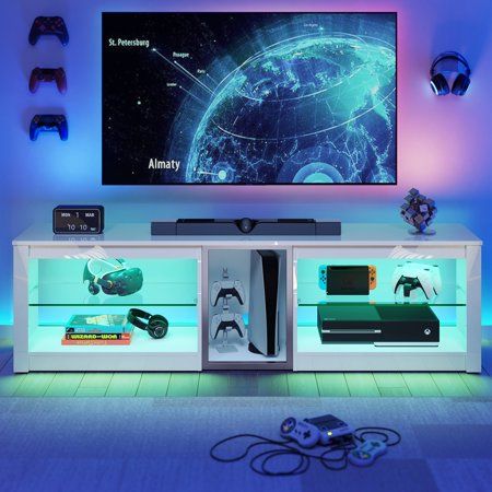 the entertainment center is illuminated by blue lights and features an interactive video game system that also includes remote controls