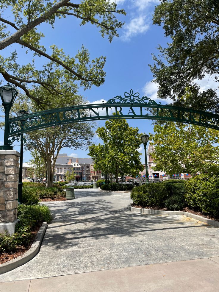 the entrance to an area with trees and bushes