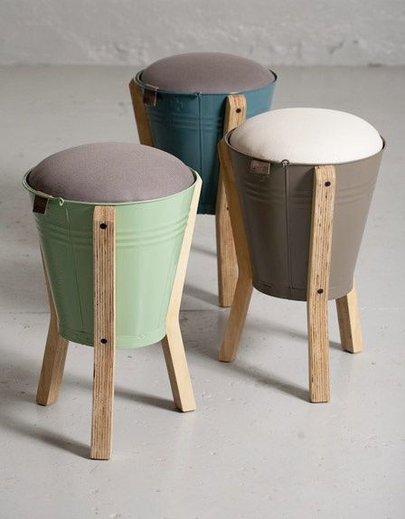 three stools with different colors and designs on each one, sitting side by side