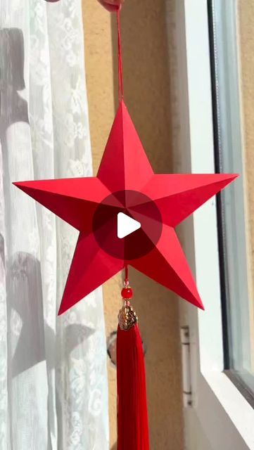 a red star hanging from the side of a window