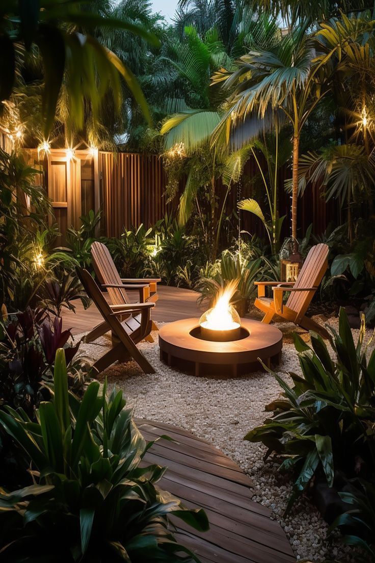 an outdoor fire pit surrounded by tropical plants