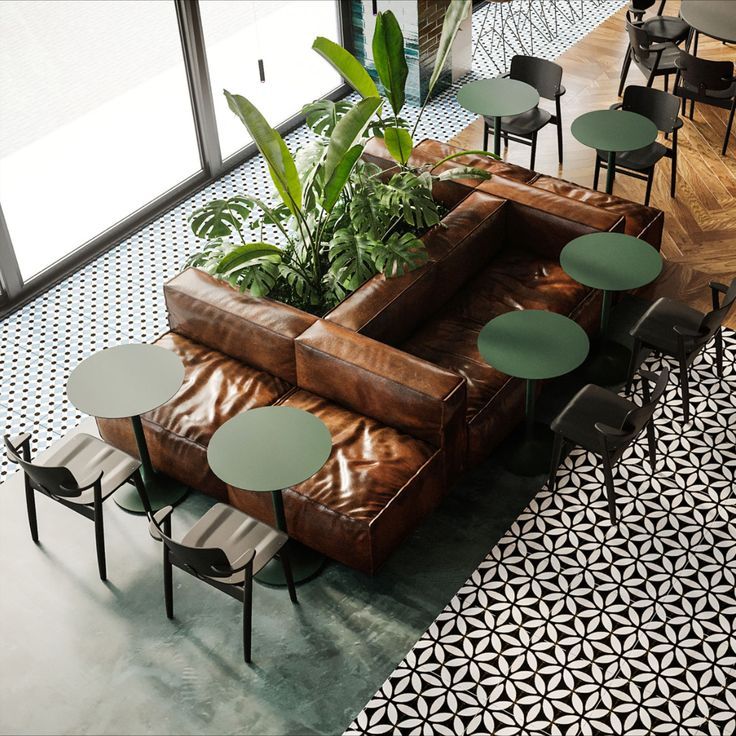 a living room filled with lots of furniture and plants