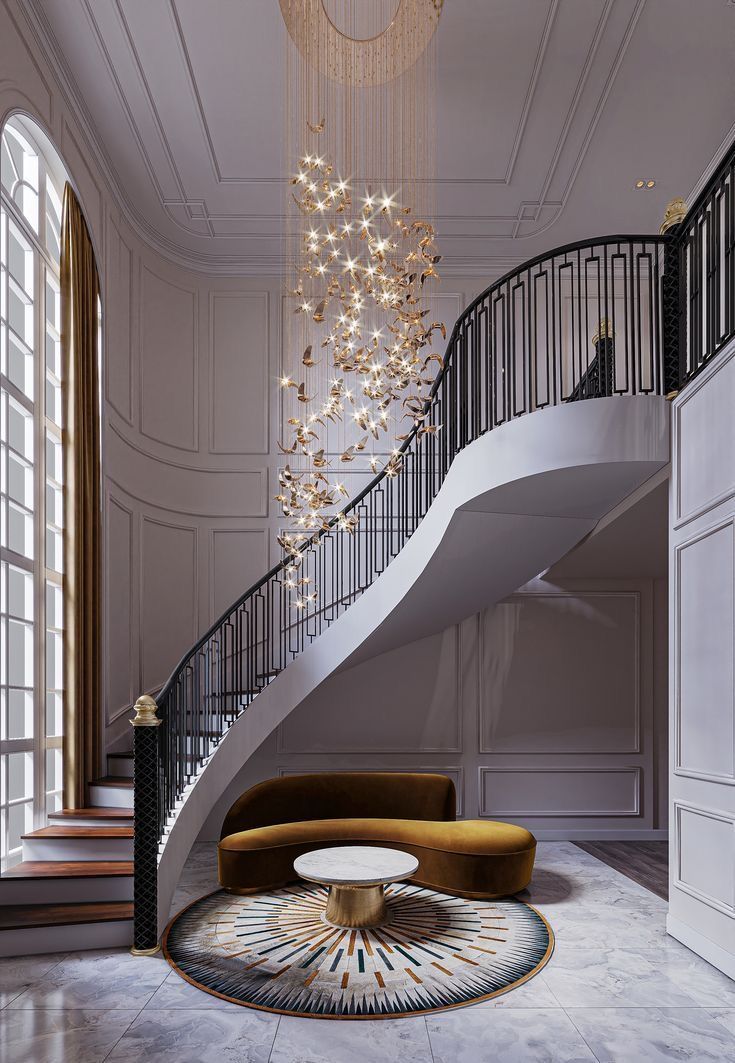 an elegant staircase with chandelier and round table