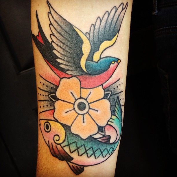 a colorful tattoo with birds and flowers on the arm