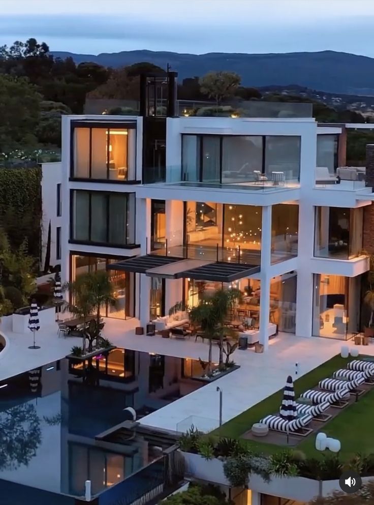 an aerial view of a modern house at dusk