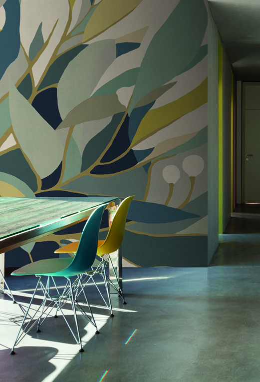 a dining room table and chairs in front of a colorful wall