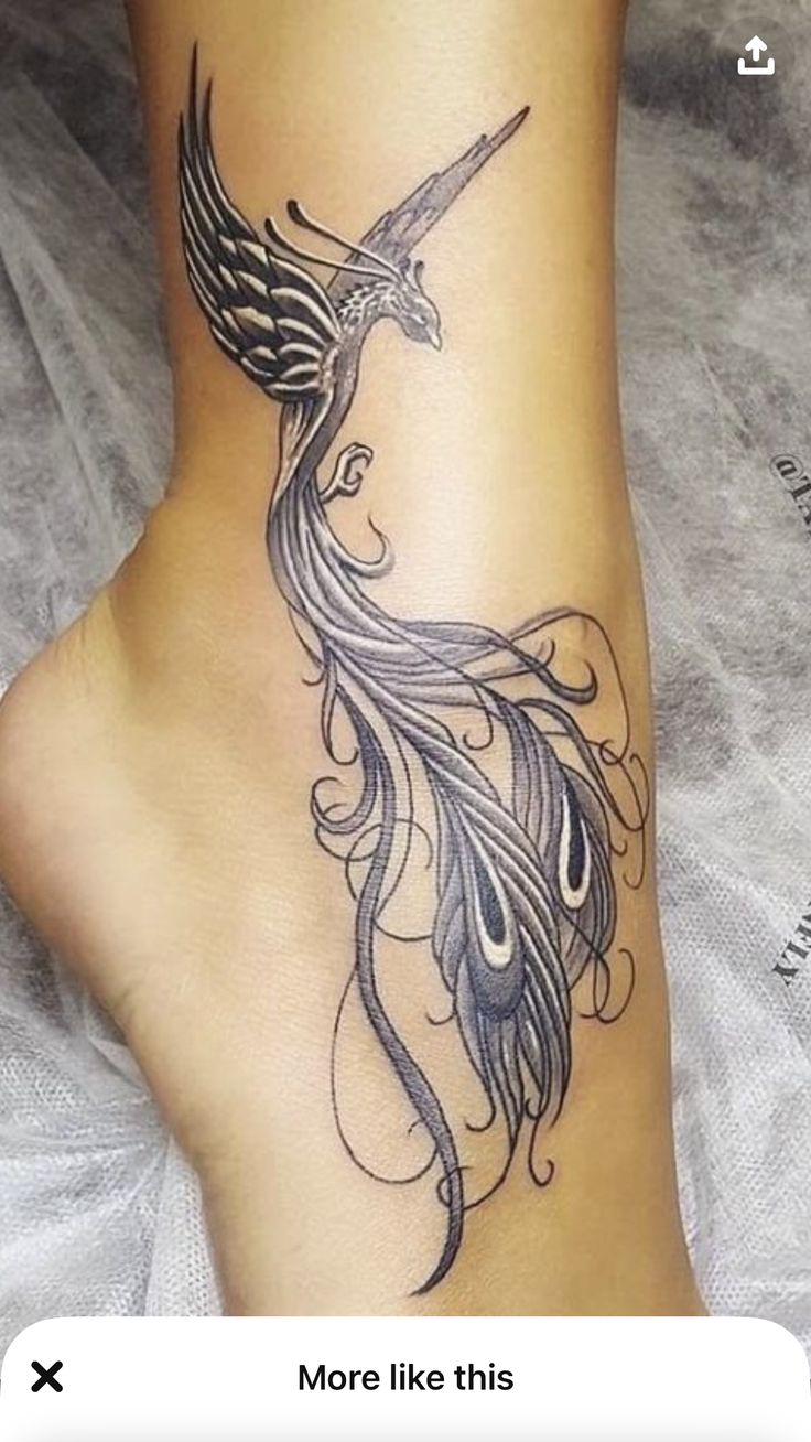 a woman's foot with a bird tattoo on the top and bottom of it