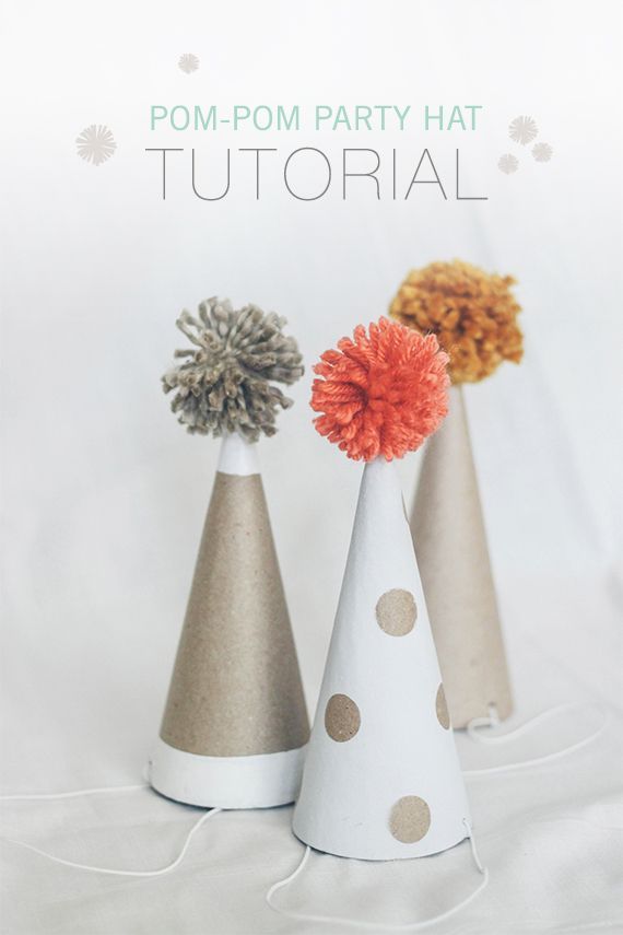 three party hats with pom - pom flowers in them