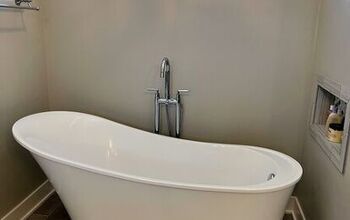 a white bath tub sitting inside of a bathroom