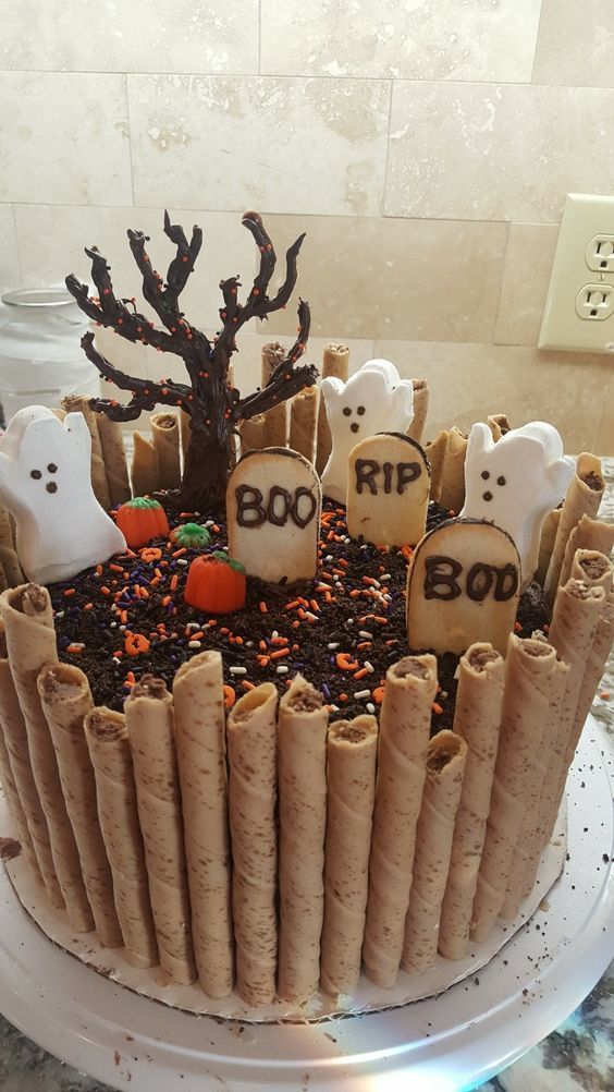 a cake decorated with halloween treats and decorations