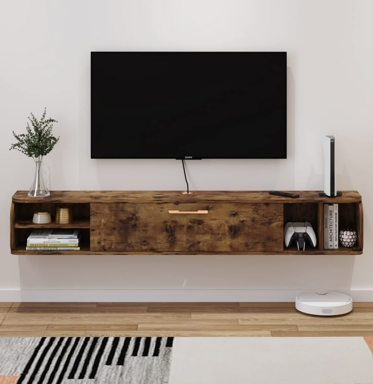 a flat screen tv mounted to the side of a wooden shelf in a living room