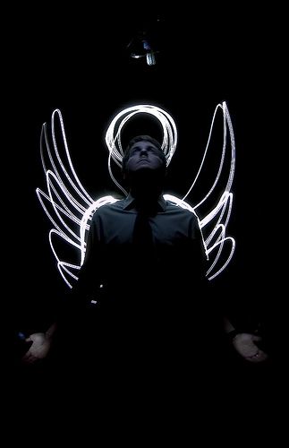 a man standing in the dark with angel wings