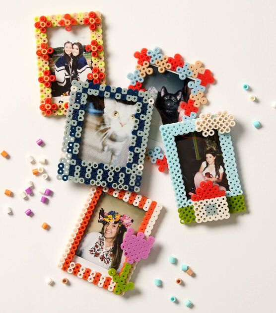 four different colored frames with beaded designs and beads scattered around them on a white surface