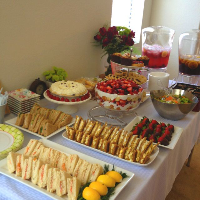 an assortment of sandwiches and fruit on a table at a brunch party or gathering