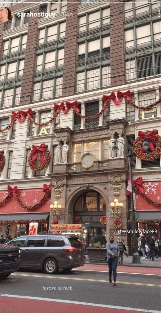 a large building with christmas decorations on it's front and side windows that are decorated for the holiday season