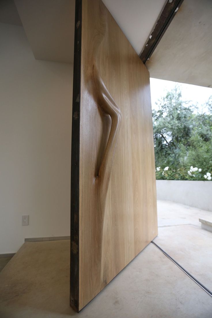 a wooden door with a carved figure on it