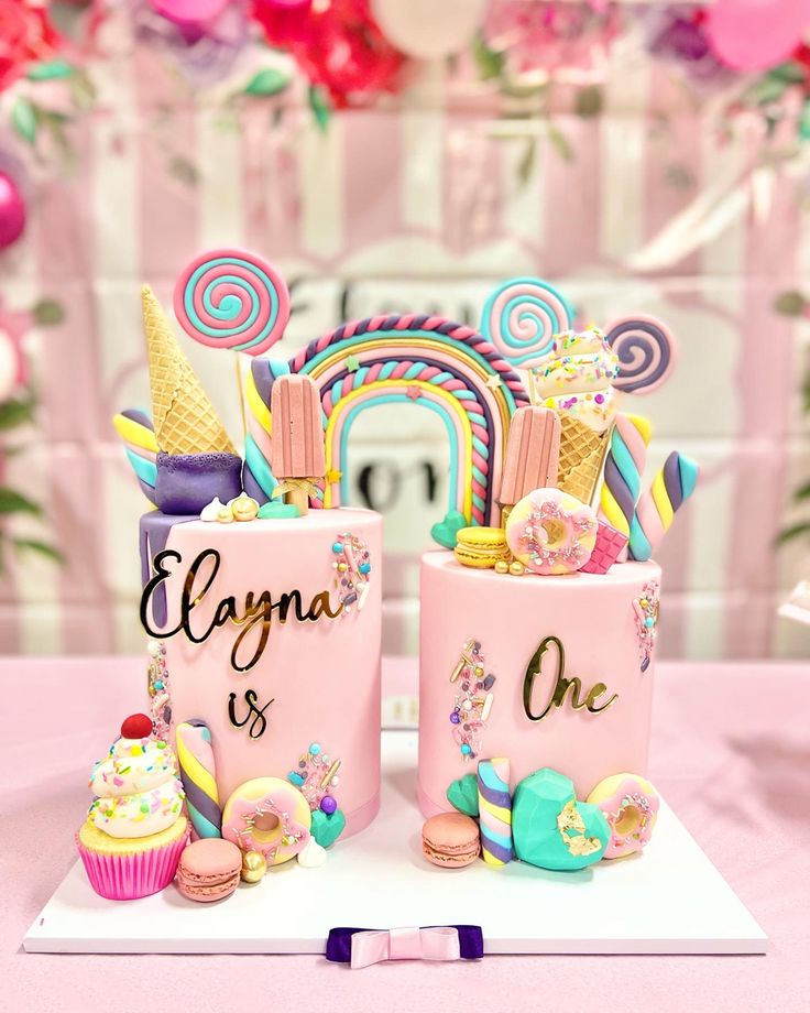 two pink mugs with unicorn themed decorations on them sitting on top of a table