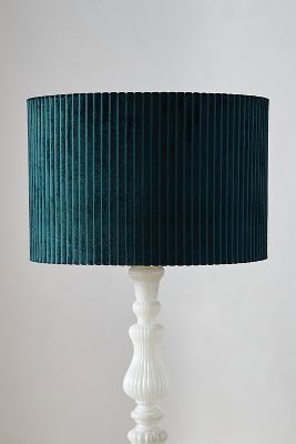 a white table lamp with a green shade on the base and a black corded lampshade