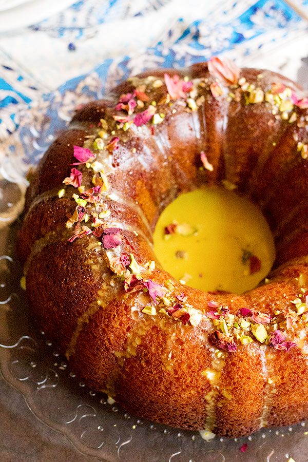 a bundt cake with sprinkles and a yellow candle in the middle