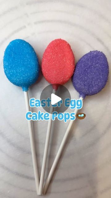 three colorful cake pops sitting on top of a white plate with the words east & egg