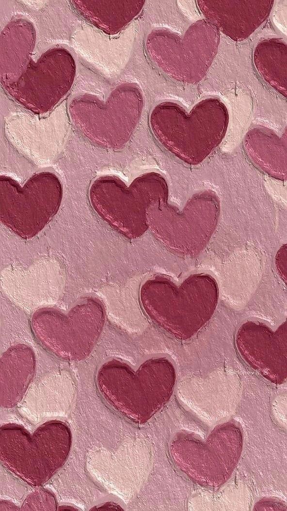 pink and red hearts painted on the side of a wall