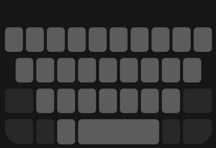 a black and white photo of a keyboard with gray squares on the back ground, in front of a dark background