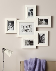 a living room with pictures on the wall and a purple blanket in front of it