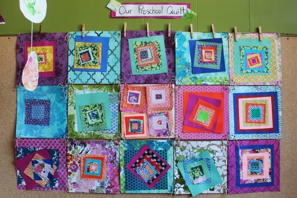 there is a wall hanging made out of squares and square designs on clothes pins in the shape of rectangles