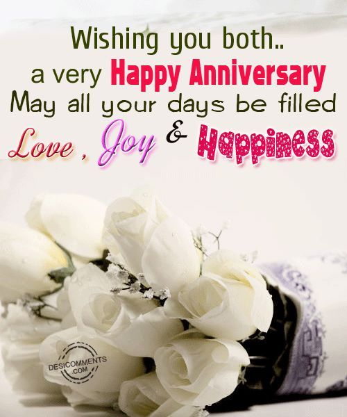 a bouquet of white roses sitting on top of a table next to a sign that says, wishing you both a very happy anniversary