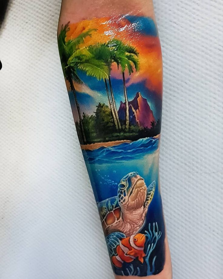 a man's arm with a colorful tattoo on it and an image of a turtle swimming in the ocean