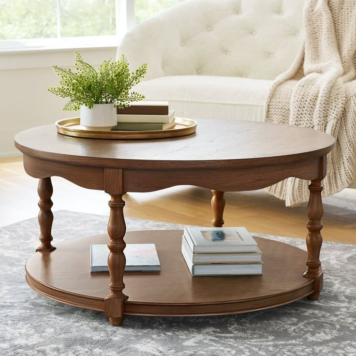 a coffee table with books on it in front of a couch