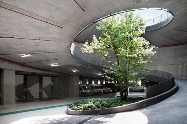 an empty parking garage with a tree in the center