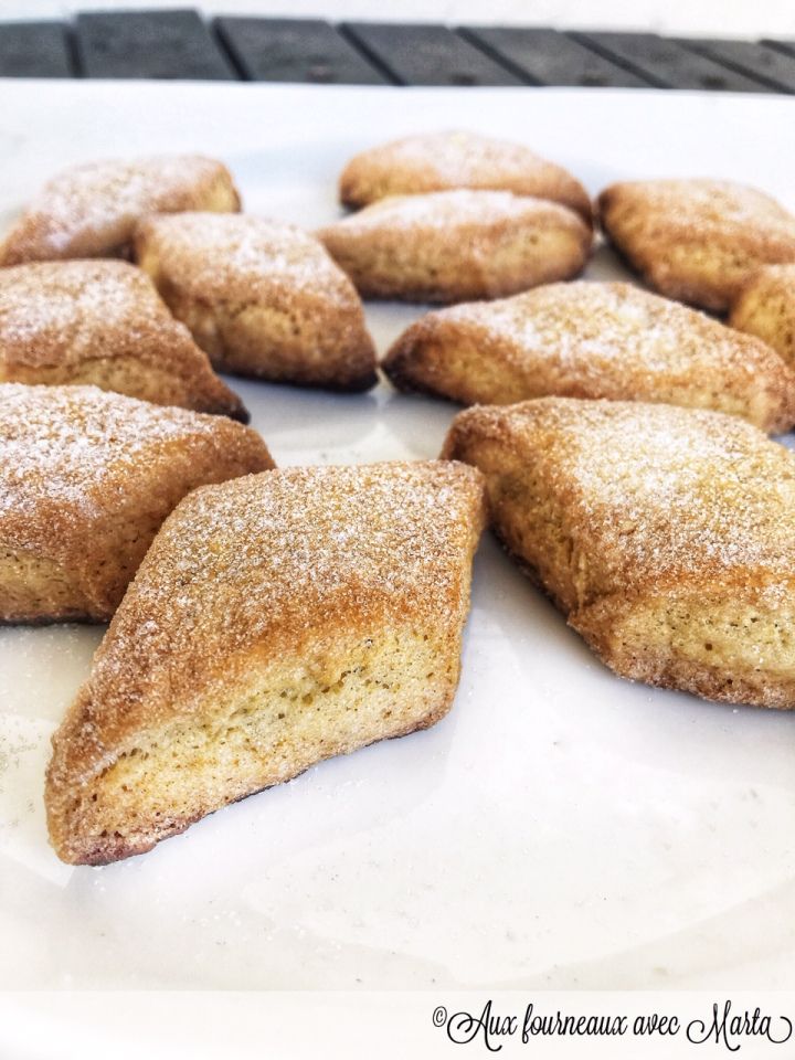 some powdered sugar cookies on a white plate