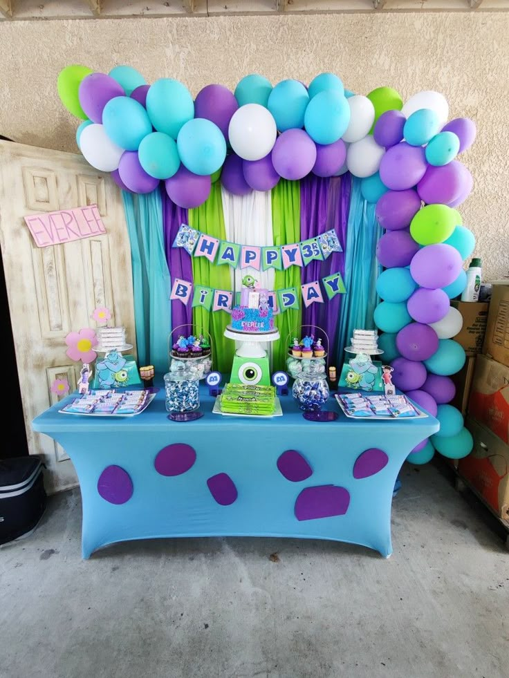 a birthday party with balloons, cake and decorations