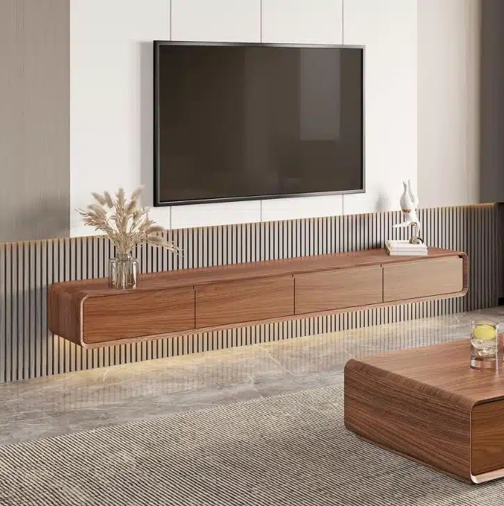 a living room with a large flat screen tv mounted on the wall next to a coffee table