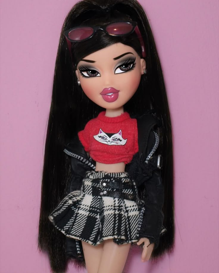 a close up of a doll wearing a skirt and jacket with sunglasses on her head