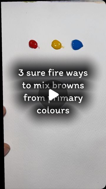 a hand holding a piece of paper with three different colored inks on it and the text, 3 sure fire ways to mix browns from primary colours