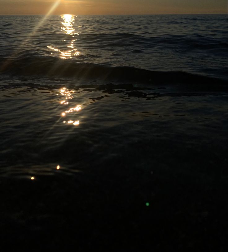 the sun shines brightly in the ocean as it reflects off the water's surface