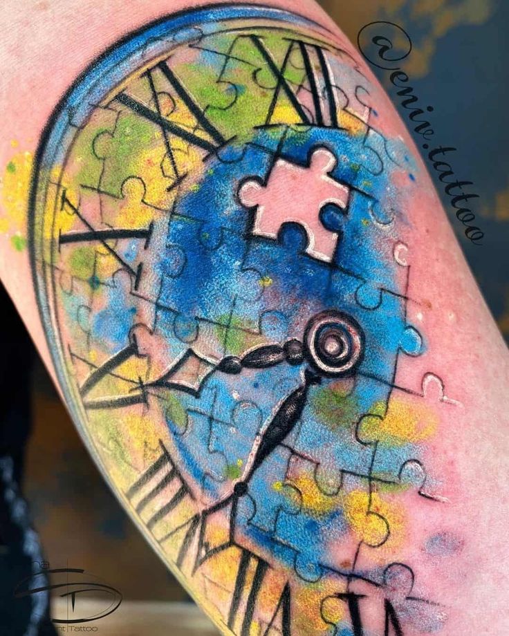 a colorful tattoo with a clock and puzzle pieces on it's arm that has been painted