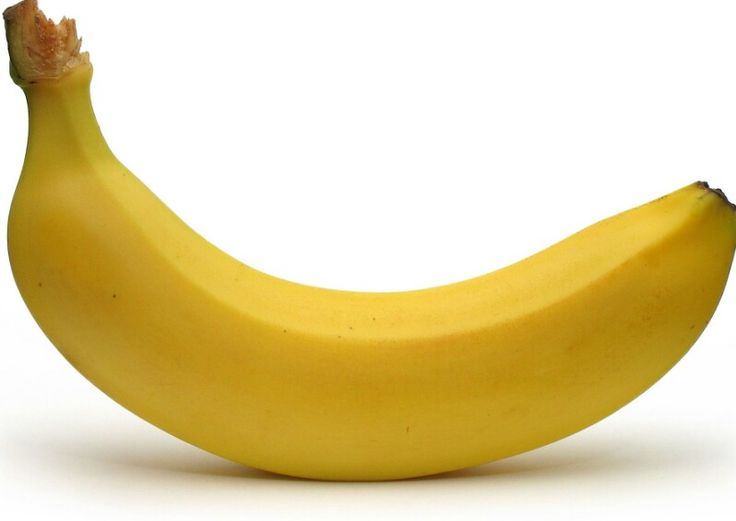 a ripe banana sitting on top of a white surface