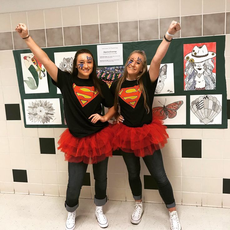 two girls dressed in costumes posing for the camera