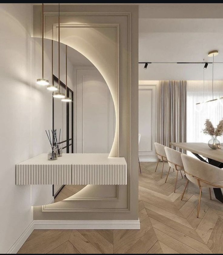 an elegant dining room with white walls and wood flooring