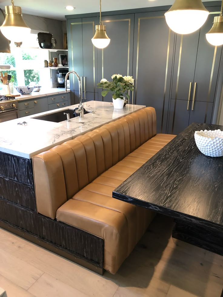 a kitchen with a table and bench in it